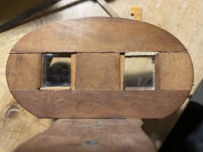 Looking at the prisms from the positon of the photo card. One prism has a piece of lightly colored wood under it, the other over it. Exactly right for my vision.