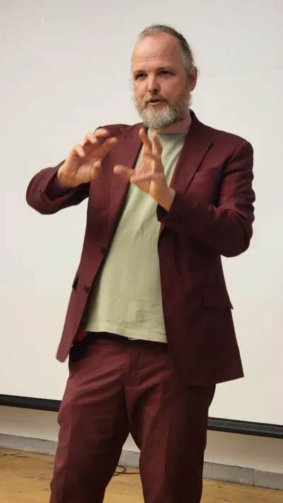 David Krooshof in a red suit talking about grabbing images. Photo by Frank Armstrong.